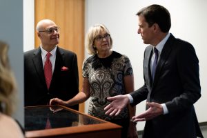 Great Returns Campaign Chair Dr. Paul Mueller '84, Fuad and Nancy admiring the Nobel Prize in Chemistry awarded to Dr. Peter Agre '70 on display in Augsburg's Hagfors Center for Science, Business, and Religion.